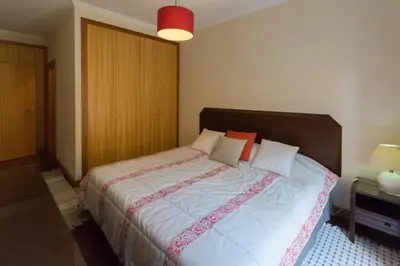 a bedroom with a large bed with white sheets and pillows at Quinta da Torre in Câmara de Lobos