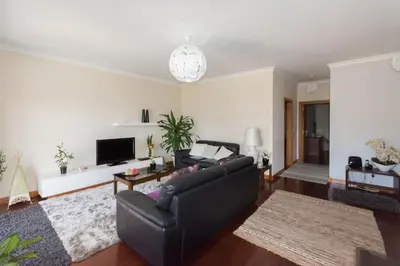 a living room with a couch and a tv at Quinta da Torre in Câmara de Lobos