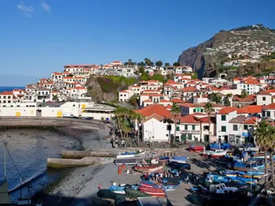 a group of boats on the beach in a town at Quinta da Torre in Câmara de Lobos