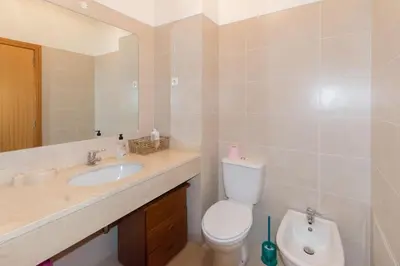 a bathroom with a toilet and a sink at Quinta da Torre in Câmara de Lobos