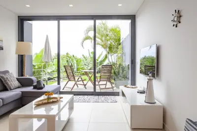 a living room with a couch and a table at Quinta Golfinho in Arco da Calheta
