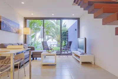 a living room with a couch and a tv at Quinta Golfinho in Arco da Calheta