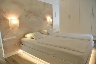 a bedroom with a large white bed with two pillows at Quinta Golfinho in Arco da Calheta
