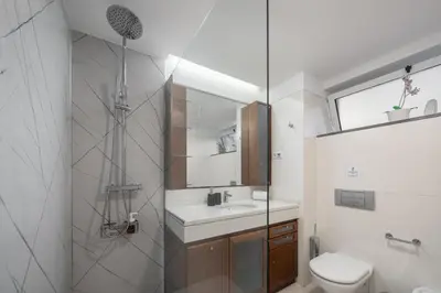 a white bathroom with a sink and a toilet at Jasmineiro I by An Island Apart in Funchal