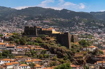 a view of a city with a castle on a hill at Jasmineiro I by An Island Apart in Funchal