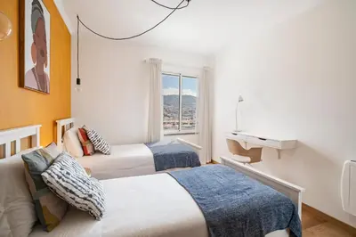 two beds in a room with a window at Jasmineiro I by An Island Apart in Funchal