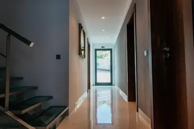 a hallway with a staircase and a glass door at Vilas Mediterrâneo in Santa Cruz