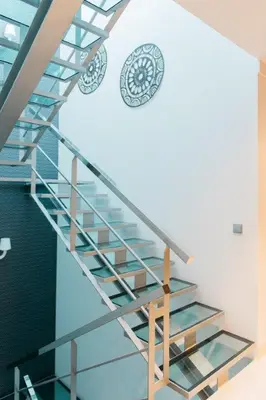 a spiral staircase in a building with a clock on the wall at Vilas Mediterrâneo in Santa Cruz