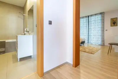 a room with a white door and a table at Apartamento Goncalves in Arco da Calheta