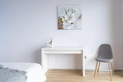 a white desk and a chair in a bedroom at Apartamento Goncalves in Arco da Calheta