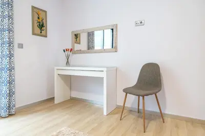 a desk and a chair in a room at Apartamento Goncalves in Arco da Calheta