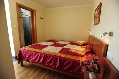 a bedroom with a bed with a quilt on it at Casa Horizonte in Arco da Calheta