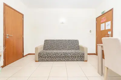 a waiting room with a chair in a room at Alojamento Local Trigal in Funchal