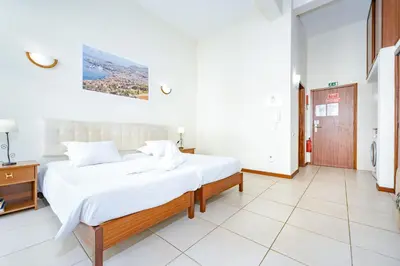 a bedroom with a large white bed in a room at Alojamento Local Trigal in Funchal