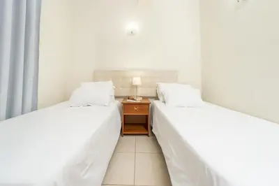 two beds sitting next to each other in a room at Alojamento Local Trigal in Funchal
