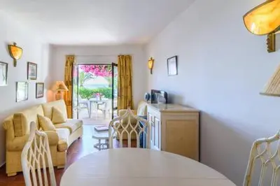 a living room with a table and a couch at Casa Sol e Praia in Luz