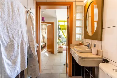 a bathroom with a sink and a mirror at Vila Morning Sun in Calheta