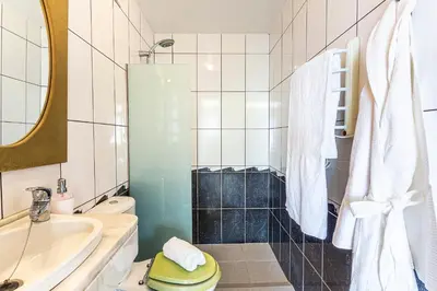 a bathroom with a sink and a toilet and a tub at Vila Morning Sun in Calheta