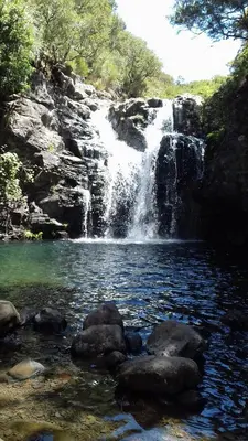 a waterfall in the middle of a pool of water at Vila Morning Sun in Calheta