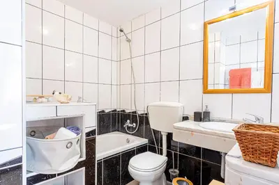 a bathroom with a toilet and a sink and a tub at Vila Morning Sun in Calheta