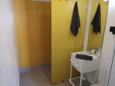 a small bedroom with a bed and a window at Hostel do Mar in Carrapateira