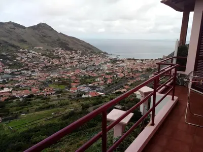 a view of a city from the balcony of a house at Moradia Cor de Rosa in Machico
