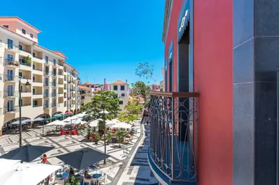 a balcony of a building with tables and umbrellas at Casa da Praça Apartments - by Casas na Ilha in Funchal