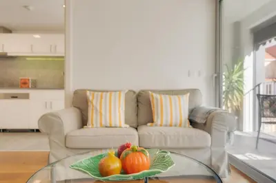 a living room with a couch and a glass table with pumpkins at Casa da Praça Apartments - by Casas na Ilha in Funchal