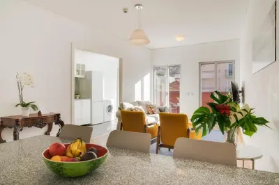 a kitchen and living room with a bowl of fruit on a counter at Casa da Praça Apartments - by Casas na Ilha in Funchal