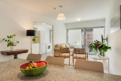 a kitchen and living room with a bowl of fruit on a counter at Casa da Praça Apartments - by Casas na Ilha in Funchal