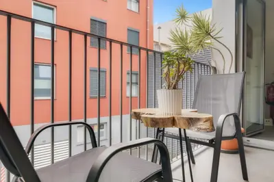 a patio with a table and chairs on a balcony at Casa da Praça Apartments - by Casas na Ilha in Funchal