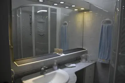 a bathroom with a sink and a shower and a mirror at Olivia's Place in Funchal