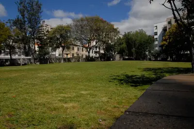 a large field of grass with buildings and trees at Olivia's Place in Funchal