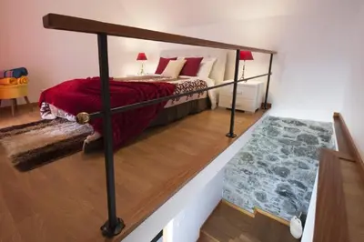 a bedroom with a bunk bed with a red blanket at Crystal House in Calheta