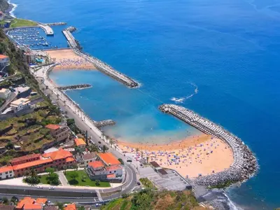 an aerial view of a beach with a pier at Crystal House in Calheta