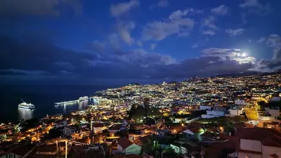a view of a city at night at Murteiras Living in Funchal