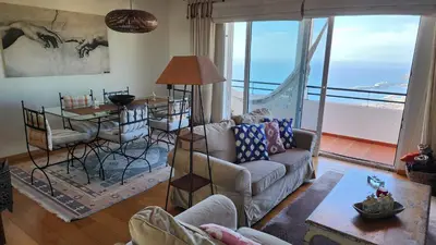 a living room with a couch and a table at Murteiras Living in Funchal