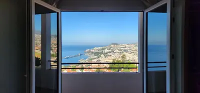 an open door with a view of the ocean at Murteiras Living in Funchal