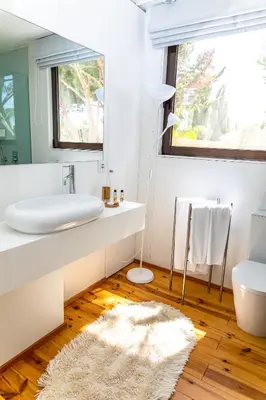 two beds in a bedroom with wooden floors at Fazenda Viegas in Lagos