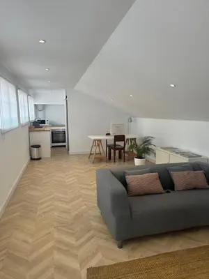 a living room with a couch and a table at Rooftop Apartment city center in Funchal