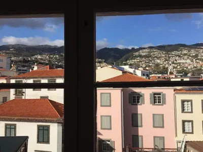 a view from a window of a city with buildings at Rooftop Apartment city center in Funchal