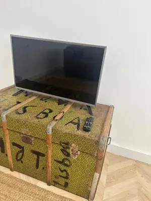 a television on top of a trunk with a tv on top at Rooftop Apartment city center in Funchal
