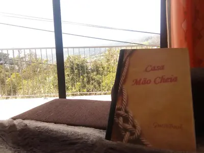 a box sitting on a bed next to a window at Casa Mao-Cheia in Arco da Calheta