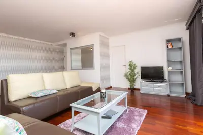 a living room with a couch and a tv at Casa dos Avós by Rent2U, Lda in Funchal