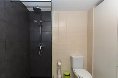 a small bathroom with a toilet and a shower at Casa dos Avós by Rent2U, Lda in Funchal