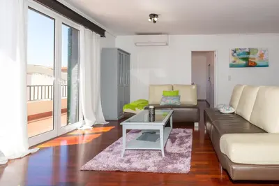 a living room with a couch and a table at Casa dos Avós by Rent2U, Lda in Funchal