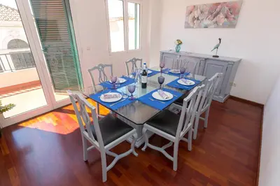 a dining room with a table with chairs and a table at Casa dos Avós by Rent2U, Lda in Funchal