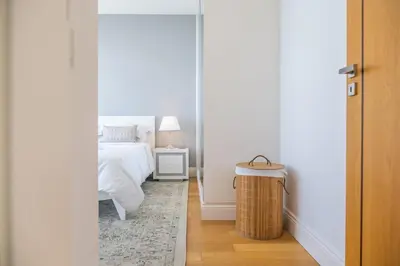 a bedroom with a bed and a night stand with a lamp at Hillside Villa in Arco da Calheta