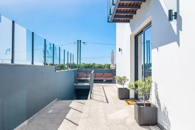 a balcony with a bench on a building at Hillside Villa in Arco da Calheta