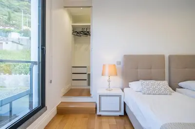 a bedroom with a bed and a window at Hillside Villa in Arco da Calheta